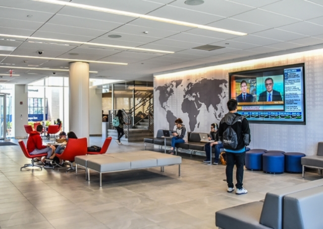 Tobin Lobby with student watching TV