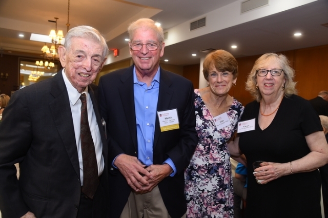 Four alumni posing for photo at alumni weekend