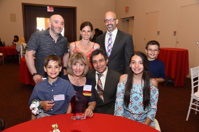 Group of people sitting at table posing for photos 