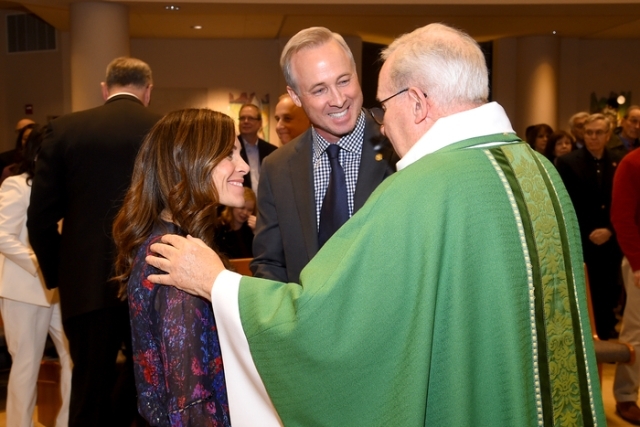 Father Tracey blessing a couple
