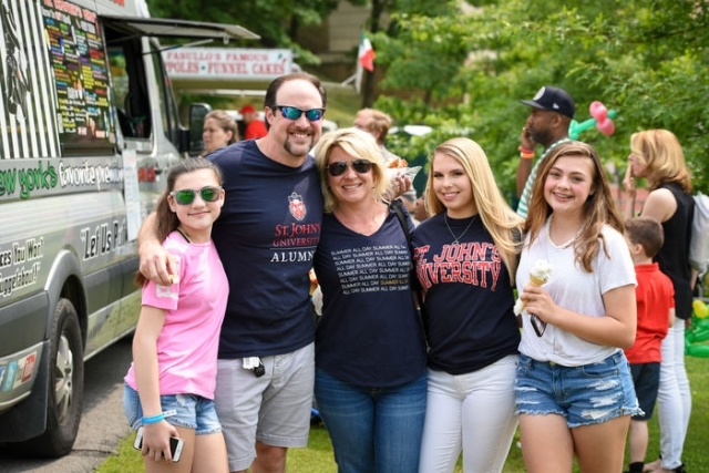 Family posing for photo at alumni event