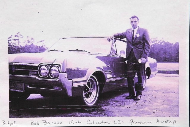 Bob Barrone standing infront of car in black and white photo