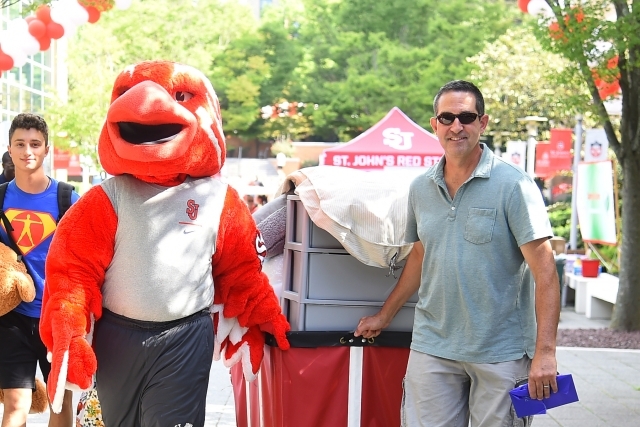 Johnny and St John's Dad pulling cart with apartment items