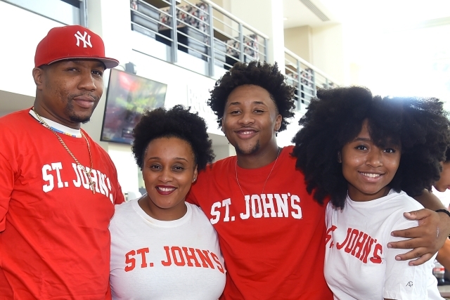Family of four posing for photo in St. John's t-shirts
