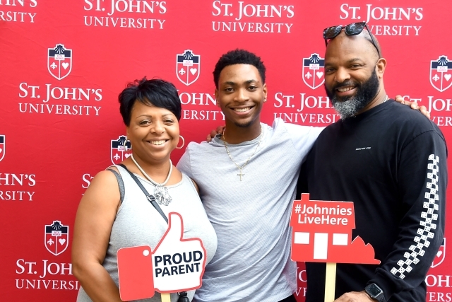 Family of 3 holding photo booth props