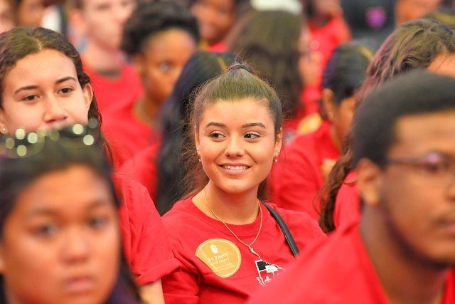 Group of students sitting at ceremony smiling
