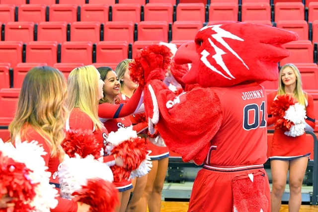 Johnny Thunderbird dancing with cheerleaders