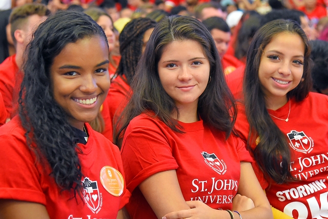 Group of students sitting at ceremony smiling