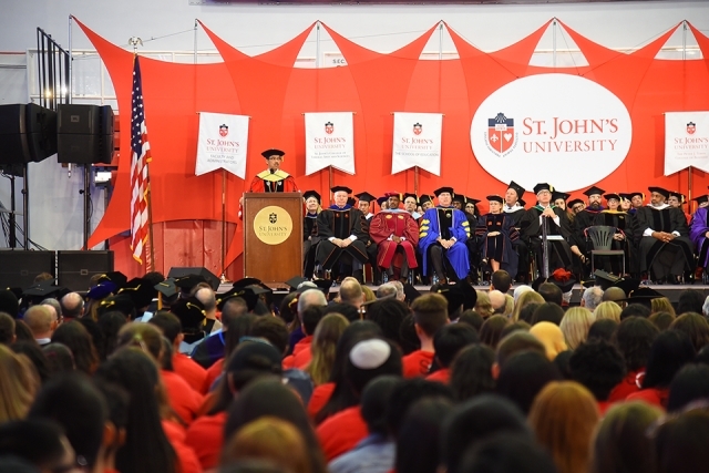Group of students sitting at ceremony smiling