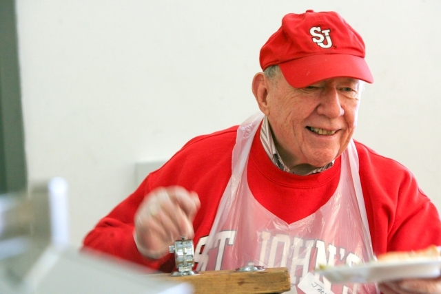 John Clarke serving food at soup kitchen