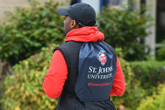Attendee wearing SJU backpack