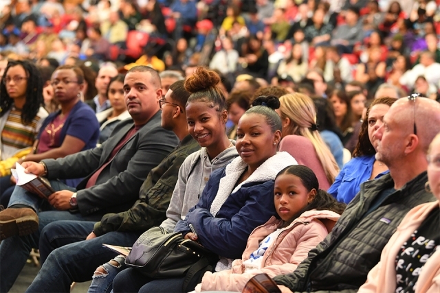 Faces in the crowd smiling at camera