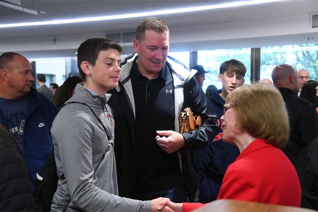 Future Johnny shakes hands with SJU faculty