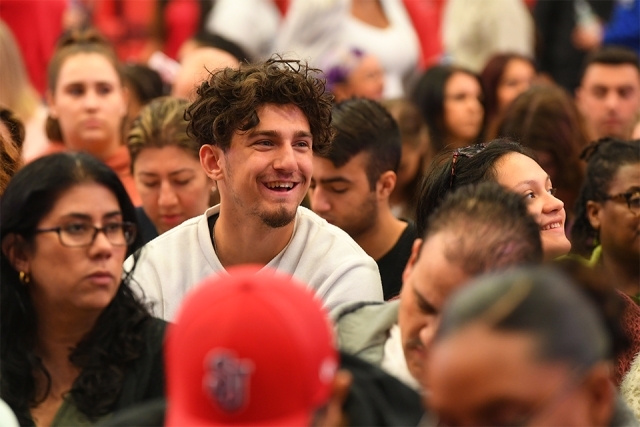 Guest smiling in welcome program crowd