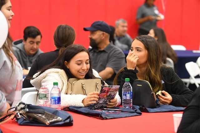 Guests reading program over breakfast