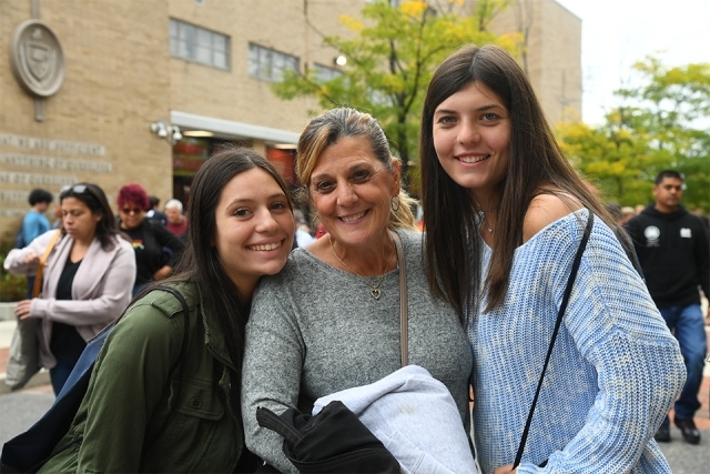 Guests smile for camera in front of Carnesseca Arena