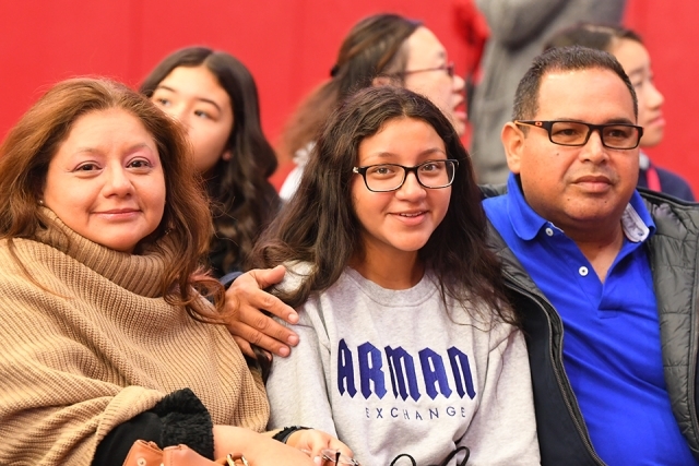 Guests smile to camera from the crowd