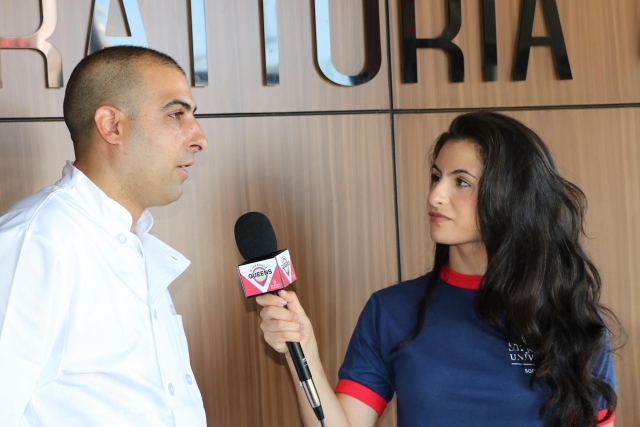 Female interviewing male holding a micophone