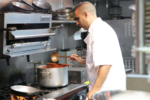 Male cooking on stove 