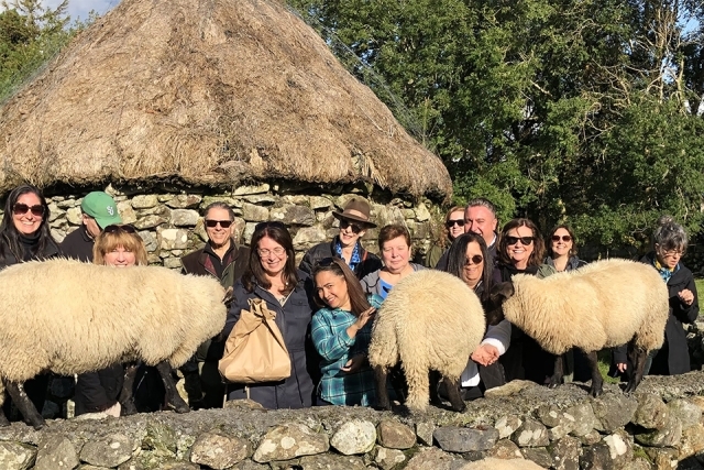 Alumni and friends with goats