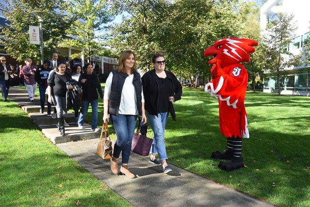 Johnny greets families and students at SI Open House