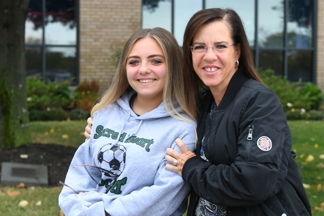 Mother and daughter smile for camera