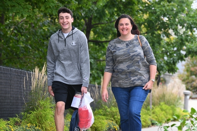 Mother and son arriving to campus