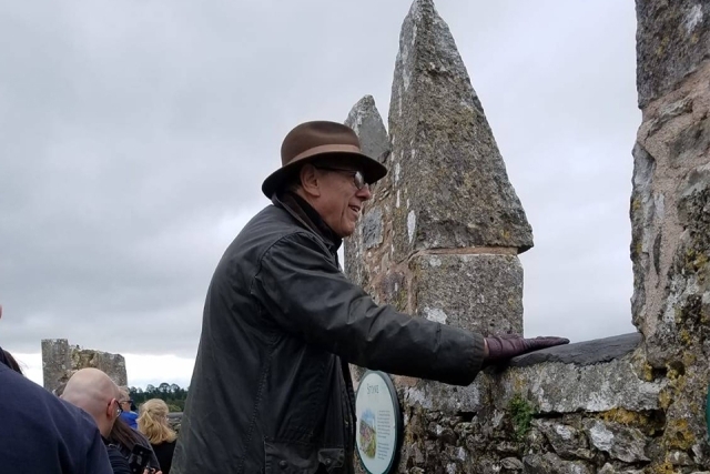 Guest touching a stone wall