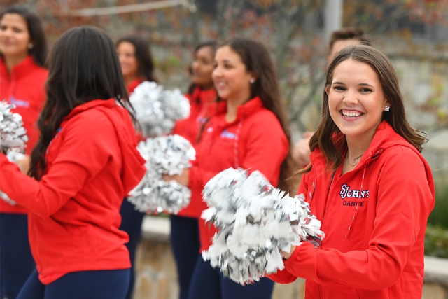 SJU cheer squad member smiling to camera