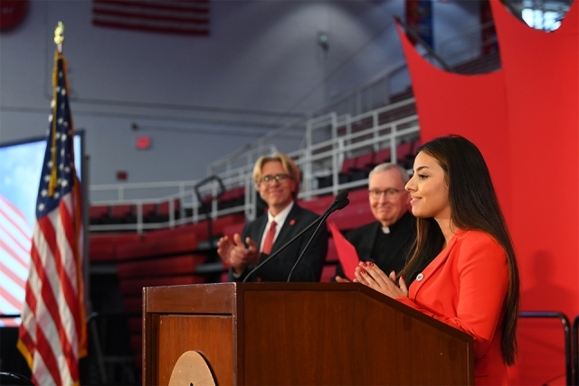 Student singer at podium on stage singing