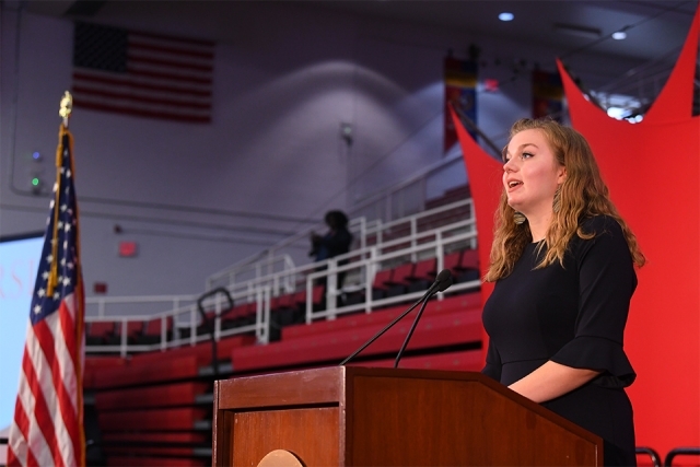 Student speaker at podium on stage
