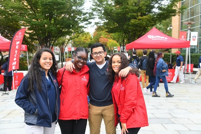 Students smile with arms around each other