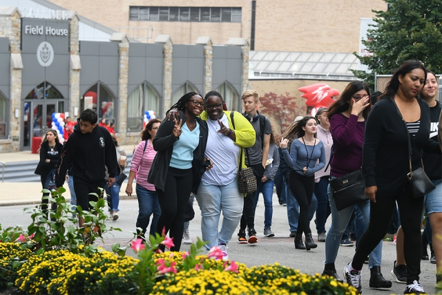 To smiling faces in a crowd walking