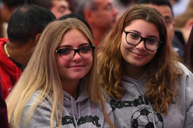 Two guests smile in matching sweatshirts