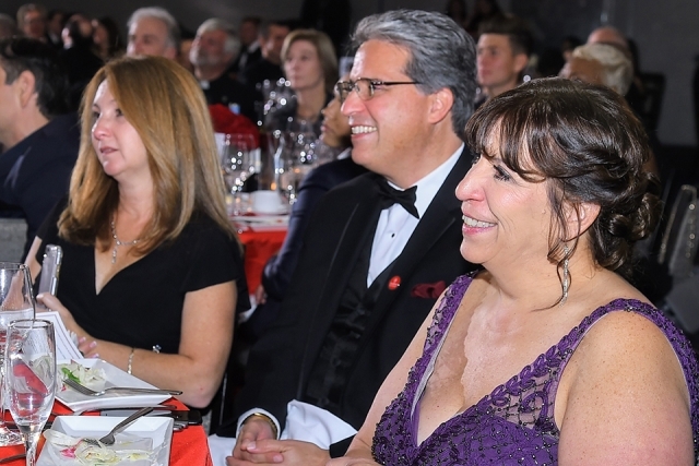 Guests smiling while seated at a table