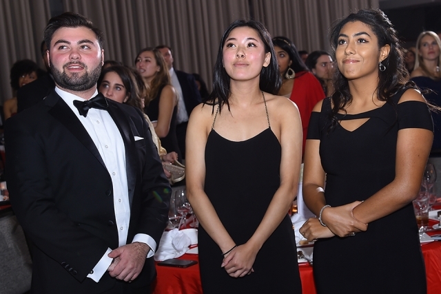Three guests standing up at a table at the St. John’s University 2019 President’s Dinner