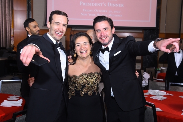 Three guests pose for a photo at the St. John’s University 2019 President’s Dinner 