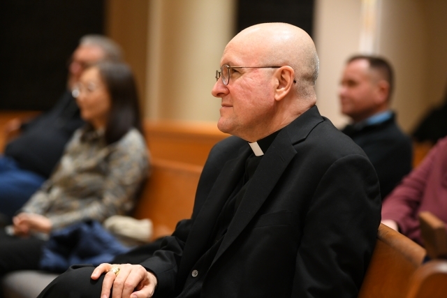 Priest sitting in the pew