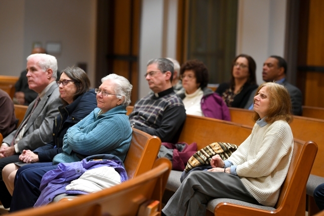 Lecture attendees sitting in the pews