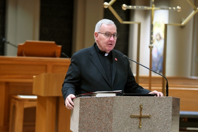 Priest speaking at the podium
