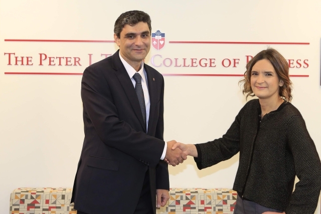 Esther Duflo shakes hands with Professor G. from St. John's