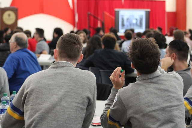 Two high school students listen to professionals in the field of Accounting