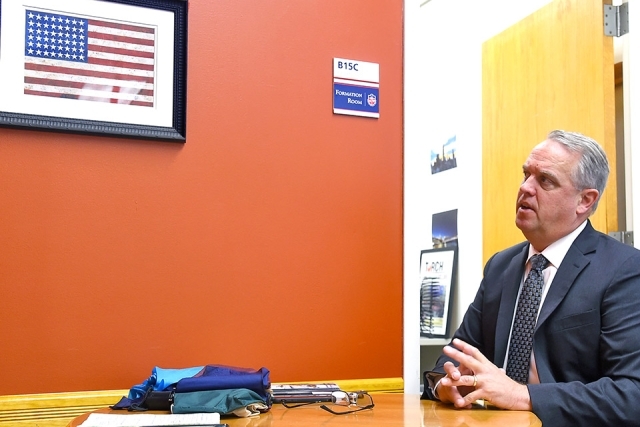 Kevin J. Killea ’88CBA looking up at American flag