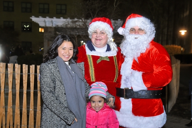 Santa poses for a photo with attendees