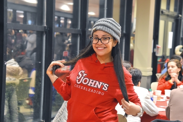 Student in a St. John's hoodie posing for a picture