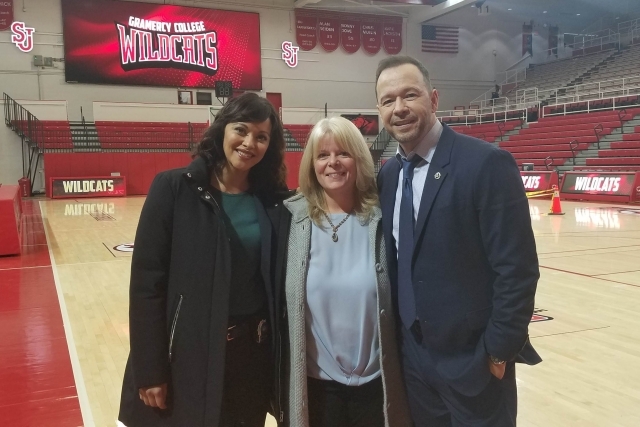 Blue Bloods Stars posing for photo with Cheryl Ohara in Carnesecca Areana
