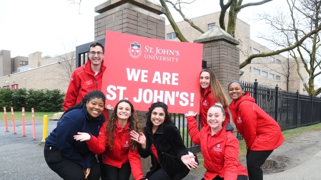 Students holding We Are St. John's Sign