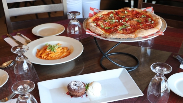 Pizza, Pasta and Cake on a table 