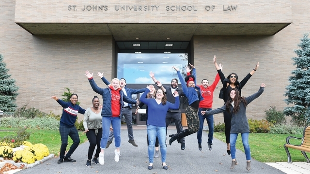 Law students jumping in front of law school.
