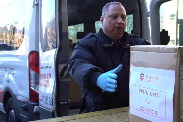 Public Safety Officer Loads PPE boxes into van